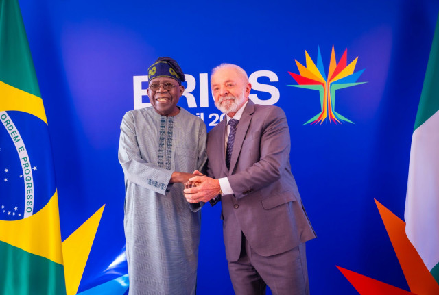 President Bola Tinubu in a handshake with President Luiz Inácio Lula da Silva of Brazil